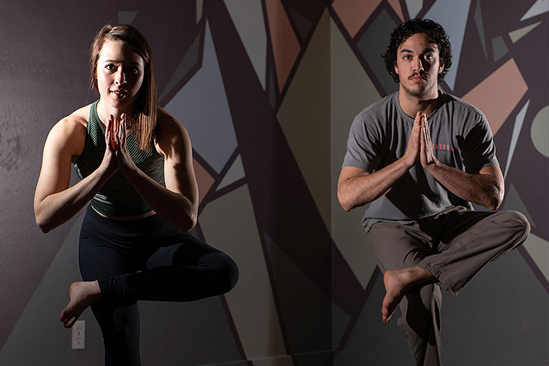 Friends doing yoga at Wild Walls Gym